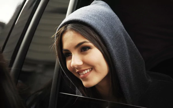 Close-up of celebrity Victoria Justice smiling while wearing a dark hoodie, captured in a high-resolution 4K Ultra HD PC desktop wallpaper background.