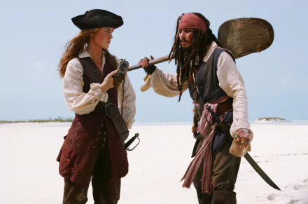 Elizabeth Swann and Jack Sparrow share a moment on a beach in this HD desktop wallpaper from *Pirates of the Caribbean: Dead Man's Chest*, featuring Keira Knightley and Johnny Depp.