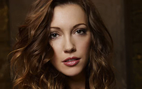 A striking HD wallpaper featuring Katie Cassidy, known for her role in the TV show Arrow, captures her expressive gaze and beautiful, tousled hair.