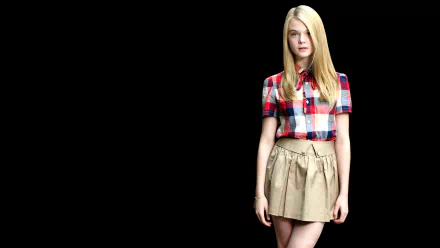 Elle Fanning poses confidently in a checked shirt and skirt against a black background, creating a striking 4K Ultra HD wallpaper for desktops.