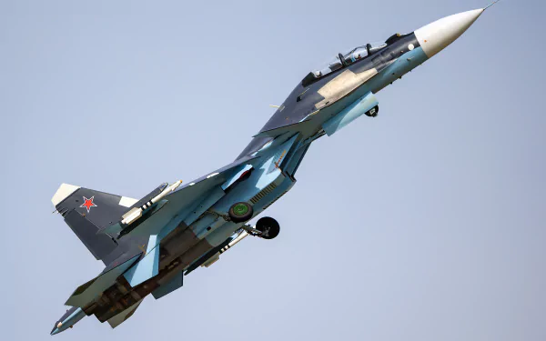 HD wallpaper featuring a military Sukhoi Su-30 jet in flight against a clear sky background.