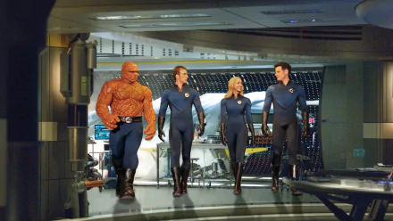 The image features the Fantastic Four: Johnny Storm (Human Torch), Susan Storm, Reed Richards, and Ben Grimm (Thing), posed in their iconic suits, showcasing a scene from the Marvel film.