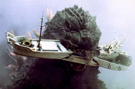 A powerful scene from the Godzilla movie, featuring the iconic creature holding boats in its mouth, set against a dramatic backdrop. HD wallpaper for an epic desktop background.