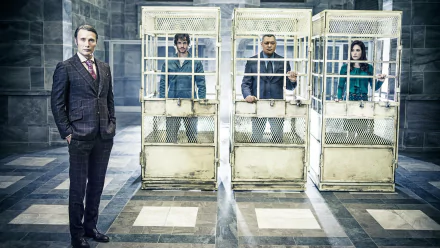 HD PC wallpaper of Hannibal TV show cast featuring Caroline Dhavernas, Hugh Dancy, Laurence Fishburne, and Mads Mikkelsen in a dramatic cage scene.
