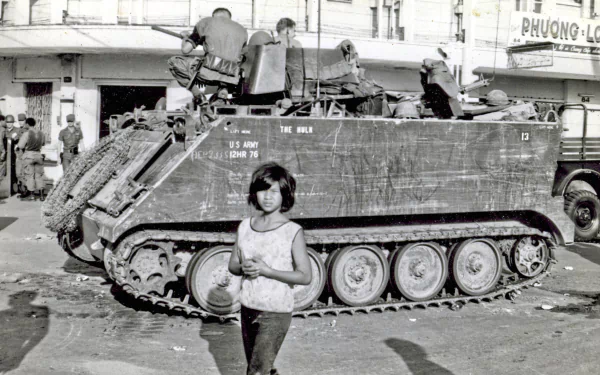 Black-and-white Vietnam War military scene showing soldiers on an armored vehicle in an urban setting, captured as an HD PC desktop wallpaper background.