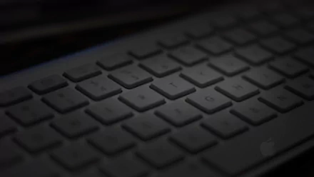A close-up of a sleek keyboard, showcasing its modern design and subtle lighting, serves as a captivating HD PC desktop wallpaper and background.
