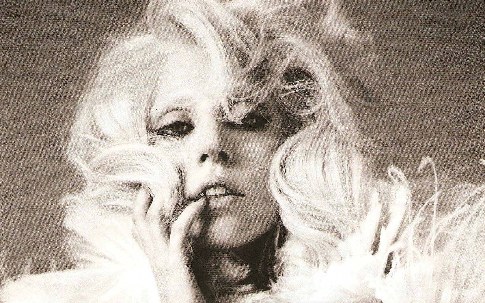 HD desktop wallpaper featuring a black-and-white close-up of Lady Gaga with voluminous hair and dramatic makeup, capturing her iconic music persona.