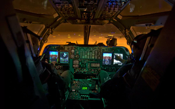 Cockpit of a Rockwell B-1 Lancer with illuminated controls and displays, set against a dramatic sunset background. High-definition image for military aviation enthusiasts.