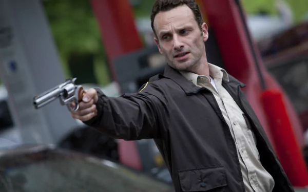 Rick Grimes, played by Andrew Lincoln in The Walking Dead, aims a gun intensely in this 4K Ultra HD PC desktop wallpaper and background.