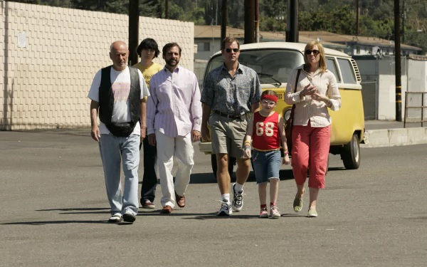 A scene from *Little Miss Sunshine* featuring Steve Carell, Toni Collette, Alan Arkin, Paul Dano, Greg Kinnear, and Abigail Breslin walking together, capturing their quirky family dynamic.