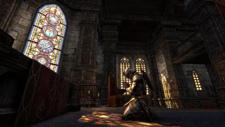 A knight kneels in prayer inside a dimly lit stone chapel with stained glass windows, a scene from the video game The Elder Scrolls Online, captured as an HD PC wallpaper.