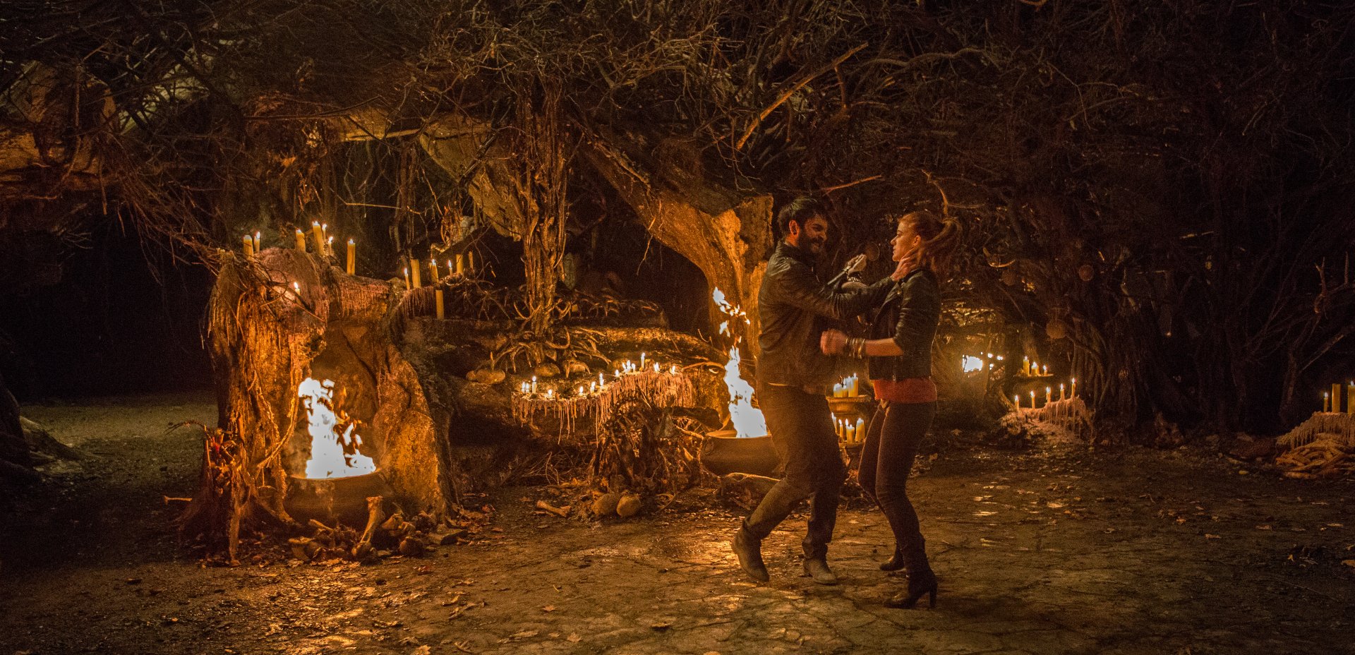 Chloe, portrayed by Rose Leslie in *The Last Witch Hunter*, dances amidst a dark, enchanted forest illuminated by candles, showcasing a mystical scene from the film.