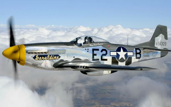 A North American P-51 Mustang, featuring the name Geraldine and marked with E2-B, soars above the clouds, showcasing its stunning design in this HD desktop wallpaper.