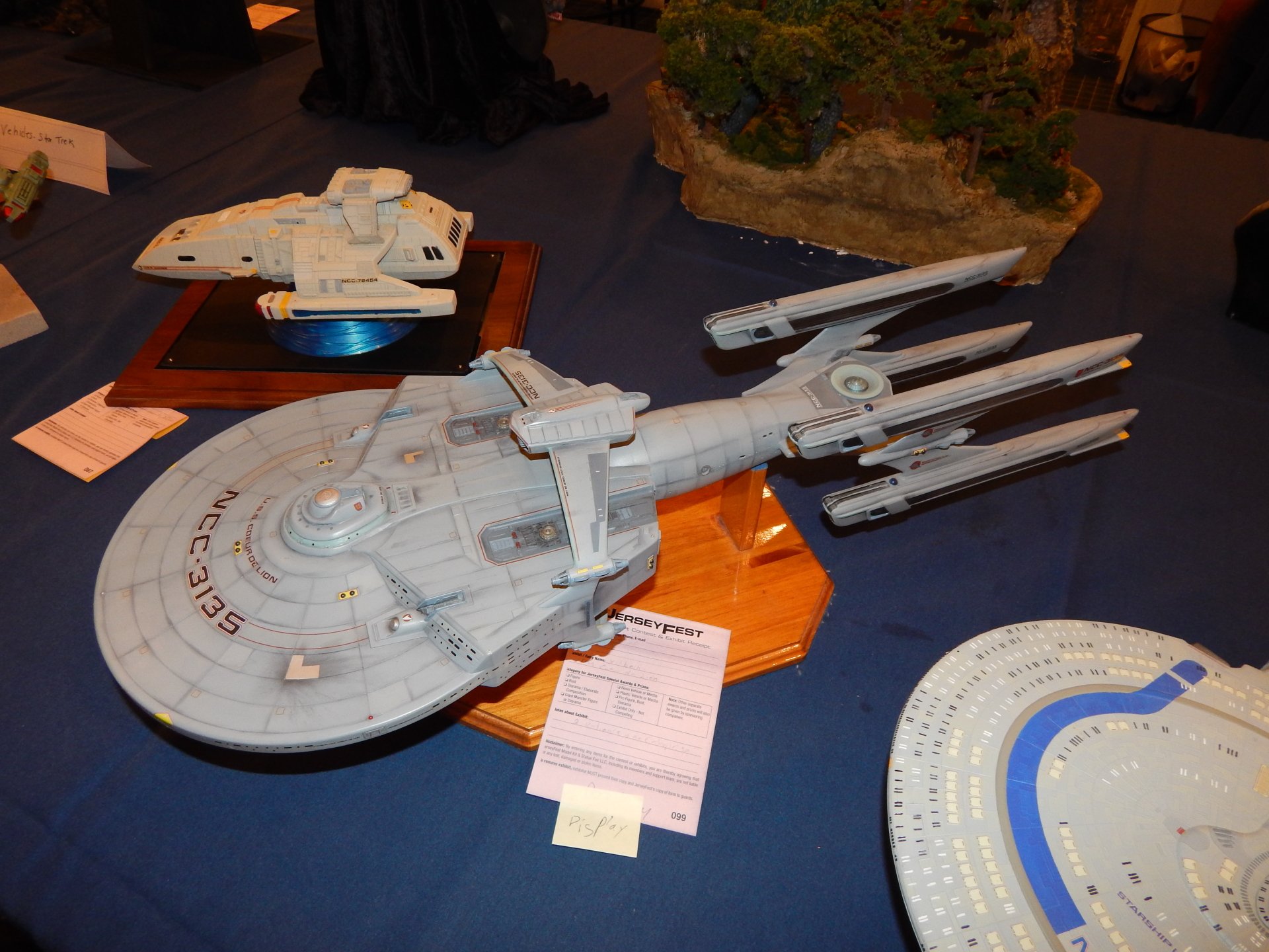 Toy Star Trek sci-fi starship models on a table, detailed saucer and nacelles, photographed as a 4K Ultra HD PC desktop wallpaper and background.