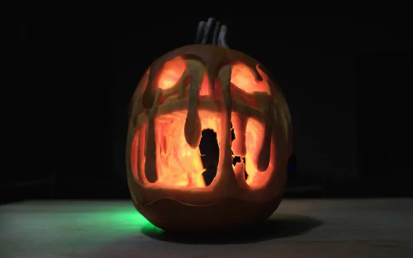 4K Ultra HD Halloween pumpkin lantern glowing in the dark, capturing the spooky holiday spirit of October with intricate carved details.