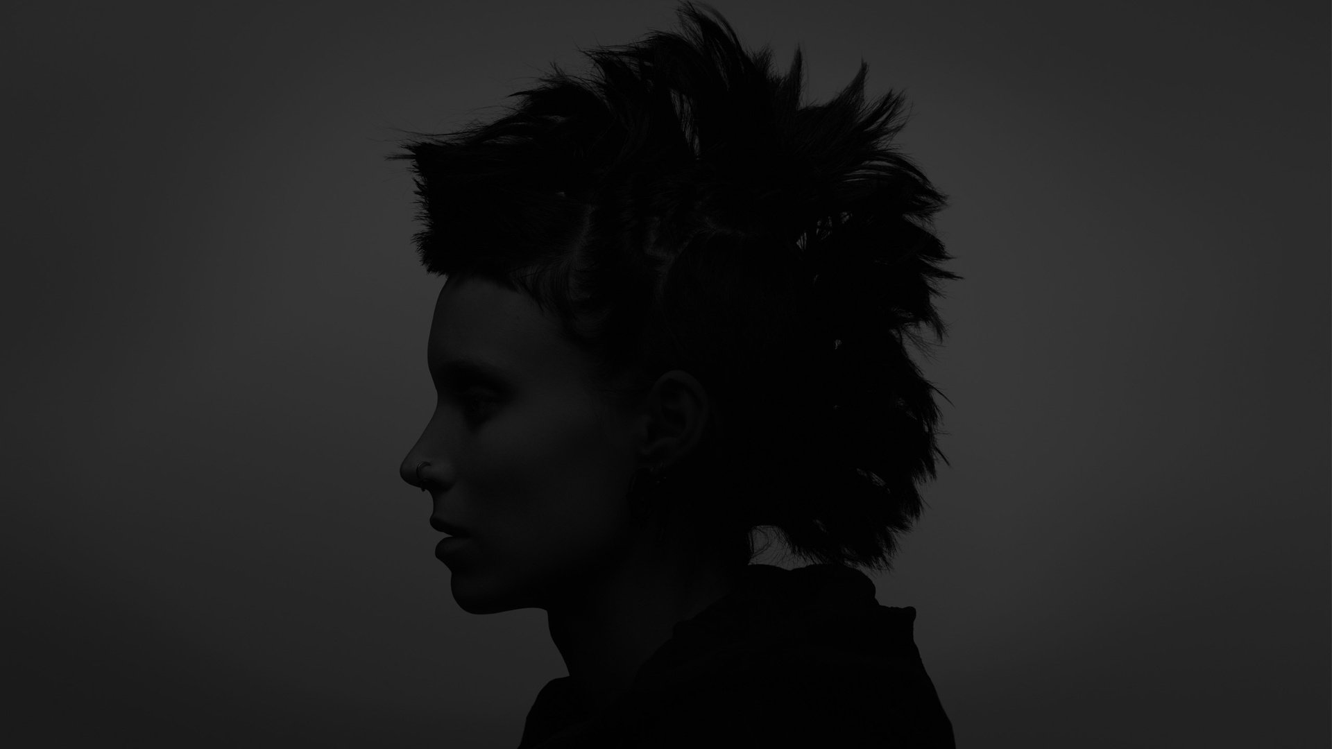 HD desktop wallpaper featuring a dark silhouette of Rooney Mara as Lisbeth Salander in the movie The Girl With The Dragon Tattoo.