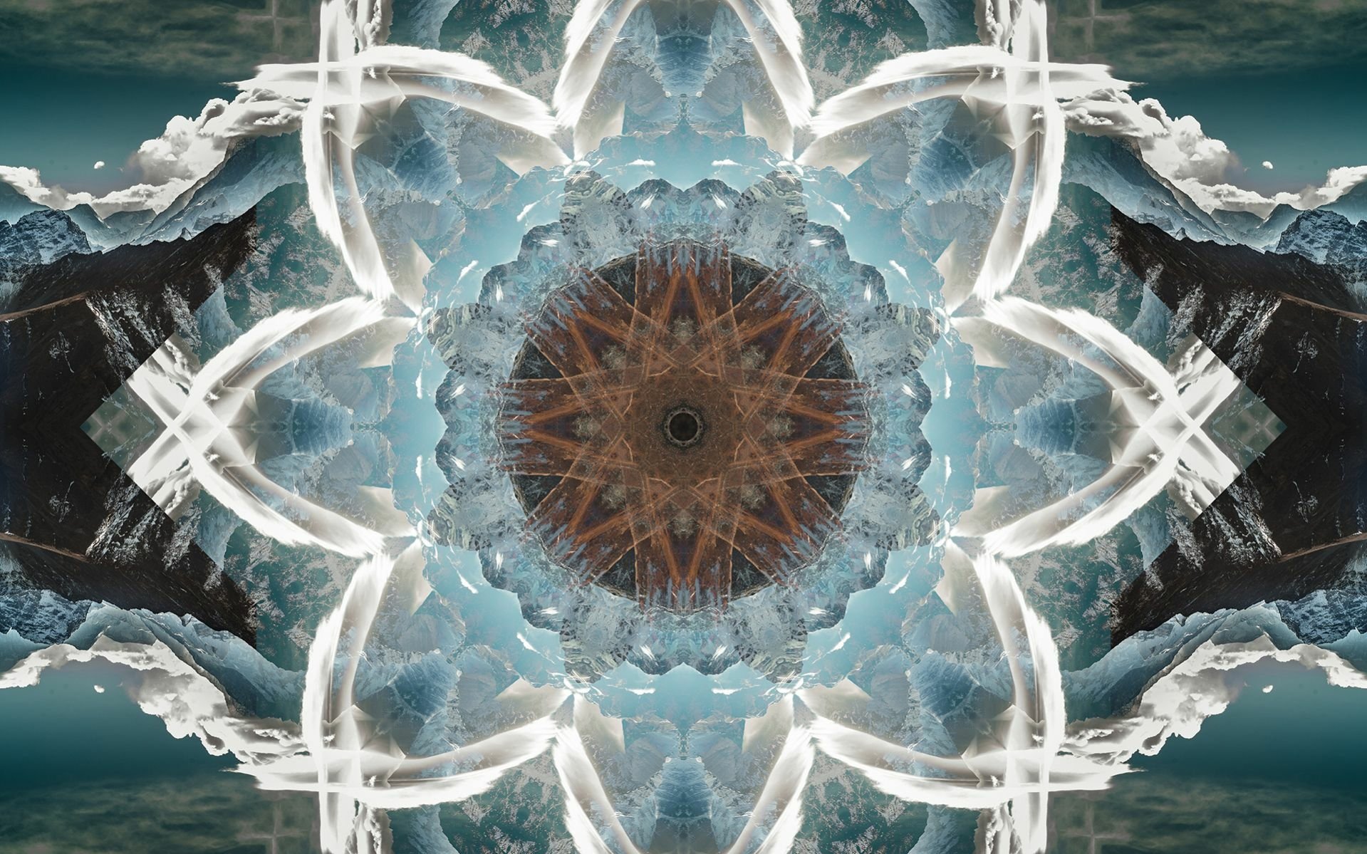 Abstract artistic mandala HD PC desktop wallpaper — radial kaleidoscope of icy blues and whites with a warm brown center set against mirrored mountain and cloud textures.