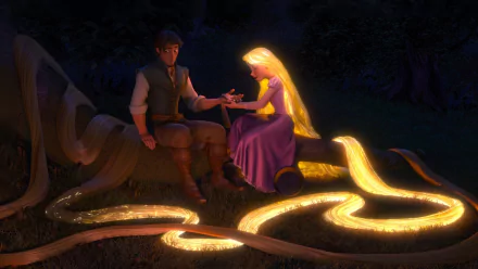 HD PC desktop wallpaper from the movie Tangled: Rapunzel's glowing golden hair coils across the grass as she and Flynn Rider sit on a log at night, sharing a quiet, tender moment.