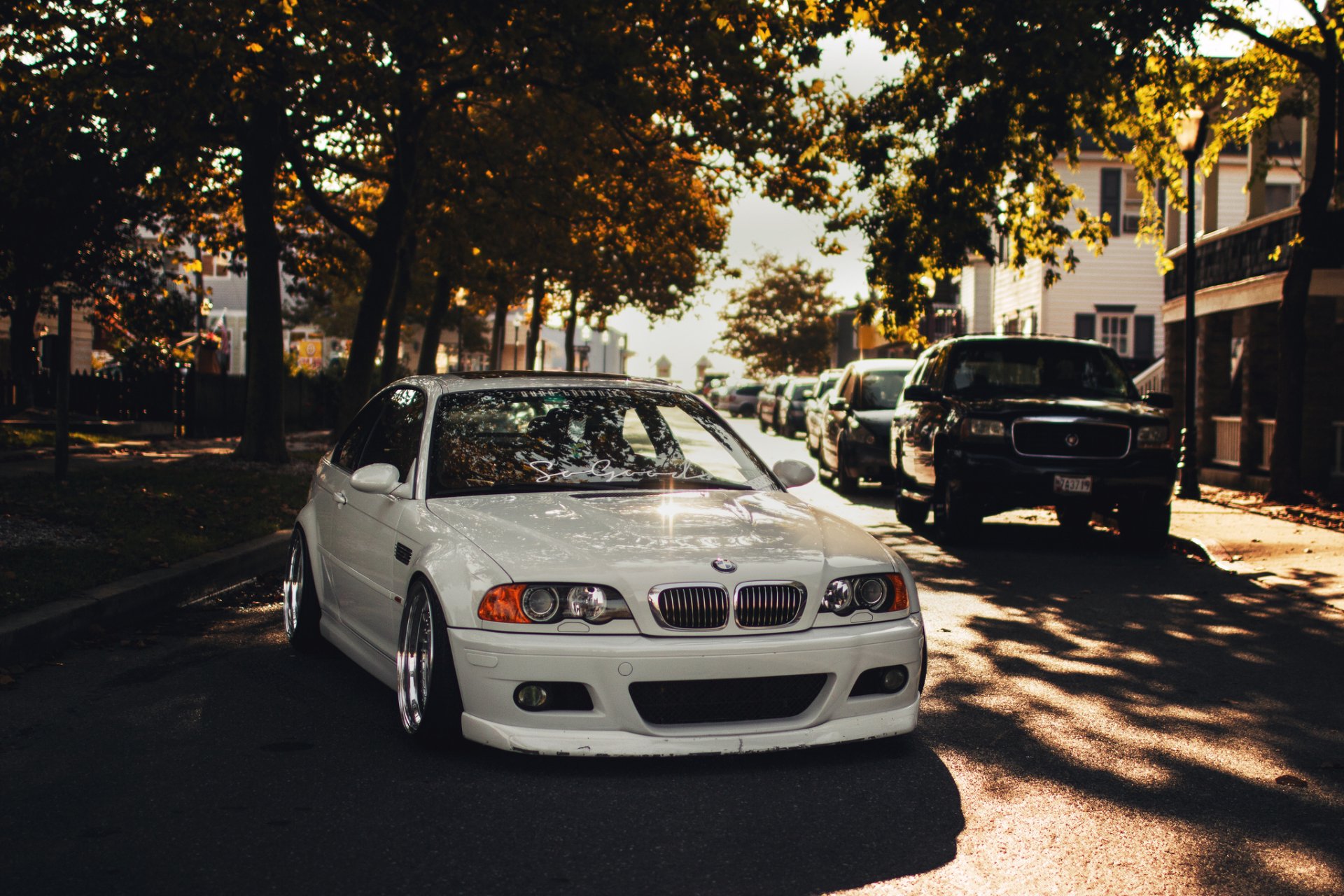 White BMW M3 car parked on a sunlit street, featured as an HD PC desktop wallpaper and background.