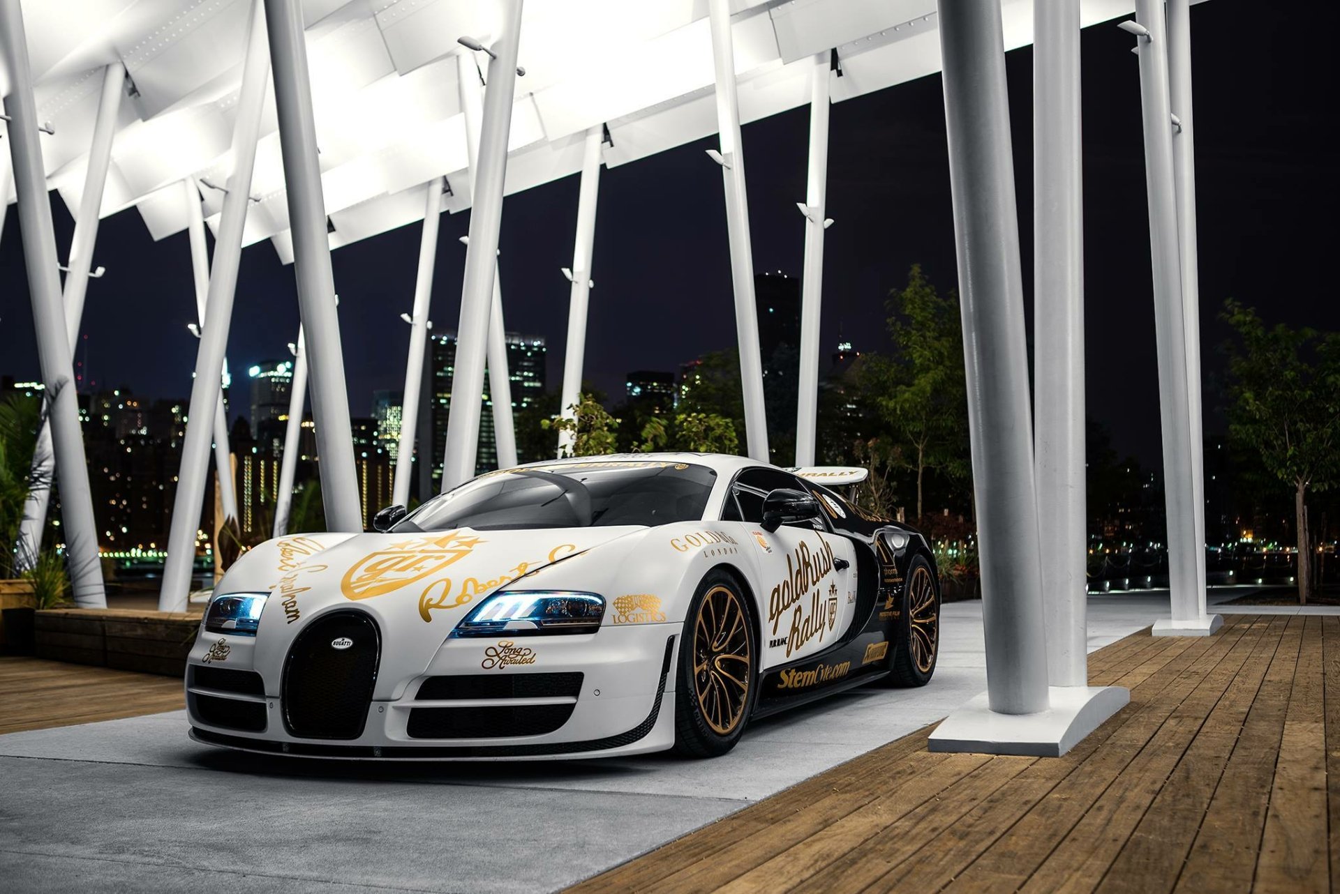 A stunning Bugatti Veyron showcased at night, featuring a striking design. This HD wallpaper captures the luxury and power of this iconic supercar against a sleek urban backdrop.