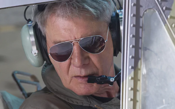 Close-up of a gray-haired pilot wearing a headset and aviator sunglasses inside a helicopter — 4K Ultra HD PC wallpaper inspired by The Expendables 3 character Max Drummer