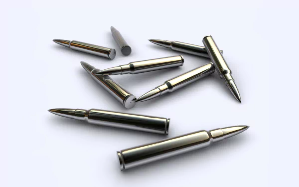 HD PC desktop wallpaper showing man-made metallic bullets scattered on a clean white background.