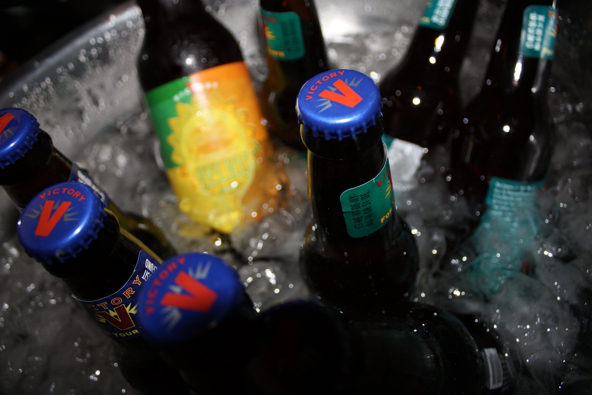 Close-up of beer bottles chilling in ice, captured in crisp 4K Ultra HD resolution for a vibrant PC desktop wallpaper featuring food and beer elements.