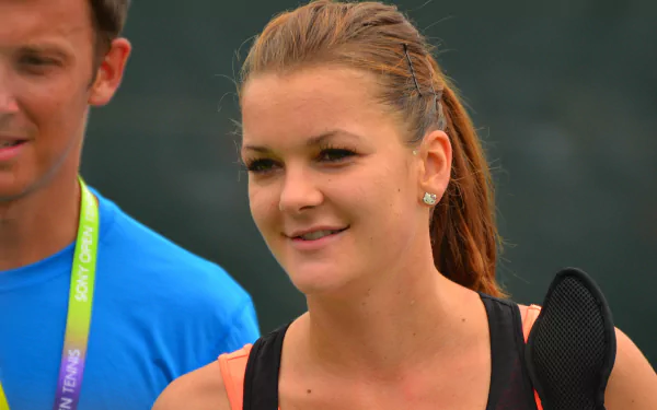 Smiling Polish female tennis player in casual sportswear at an event — portrait-style 4K Ultra HD PC desktop wallpaper/background.