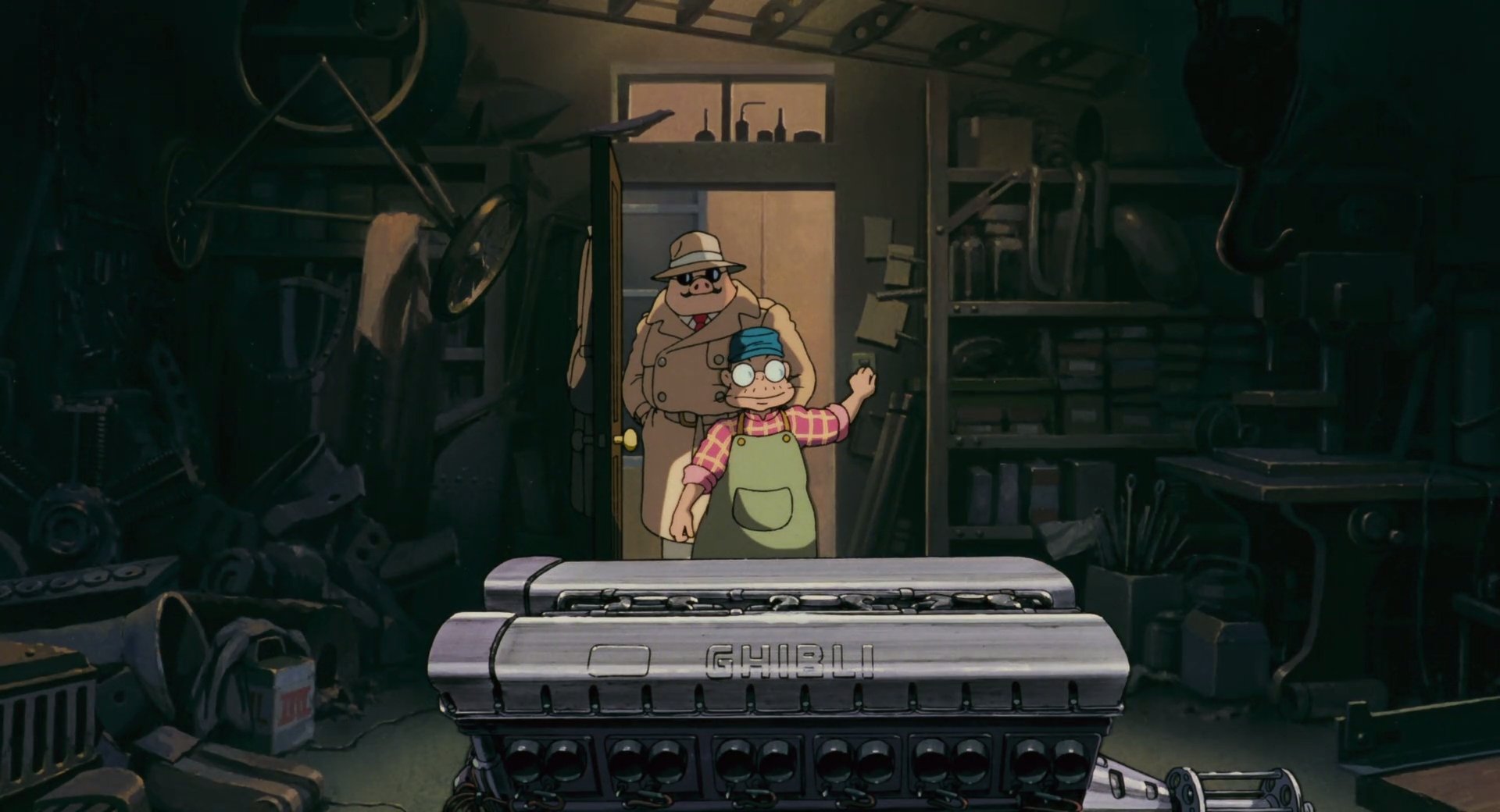 Anime HD PC desktop wallpaper and background — Porco Rosso: dim workshop hangar, mechanic in goggles holding a wrench, a man in the doorway, and a vintage seaplane engine in the foreground.