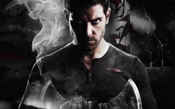 A striking HD wallpaper featuring a brooding character from the TV show Grimm, set against a dark, mysterious background with smoke and dynamic elements.