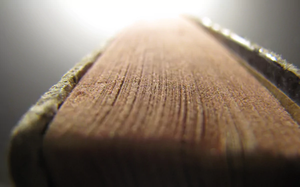 Close-up of a man-made book's spine with shallow depth of field, rendered as a high-definition PC desktop wallpaper and background.