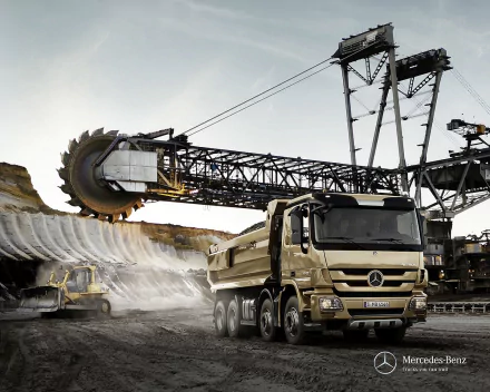 HD PC desktop wallpaper and background of a Mercedes‑Benz dump truck beside a giant excavator in an open‑pit mine, industrial vehicle and heavy machinery scene.
