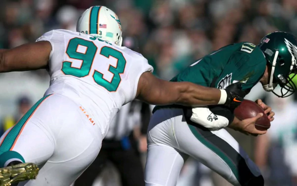 Miami Dolphins defensive lineman #93 sacks an opposing quarterback in-game — HD Miami Dolphins sports scene, PC desktop wallpaper and background.