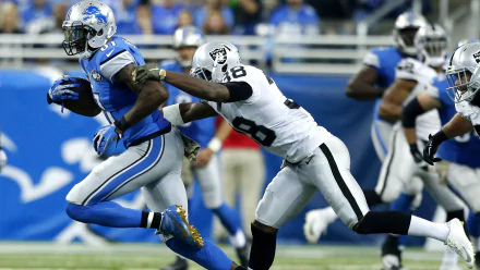HD PC desktop wallpaper background showing Las Vegas Raiders defender pursuing a Detroit Lions ballcarrier in high-speed NFL game action.