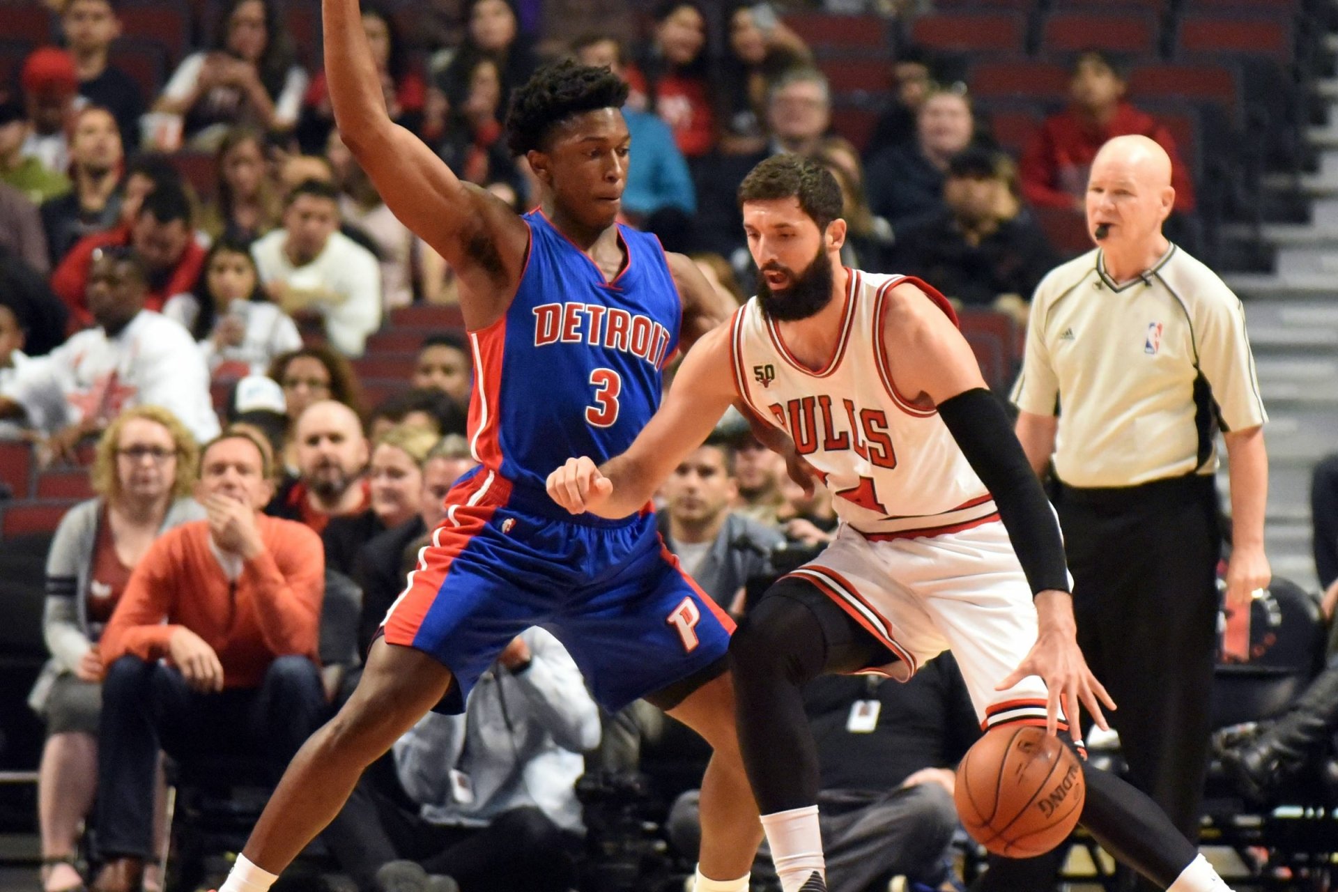HD PC desktop wallpaper featuring a Chicago Bulls player dribbling the basketball while guarded by a Detroit Pistons defender during a live NBA game.