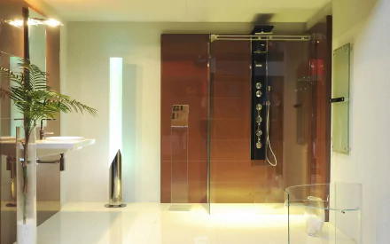 A modern bathroom featuring a sleek glass shower, minimalist design elements, and a stylish sink, showcased as a high-definition PC desktop wallpaper and background.