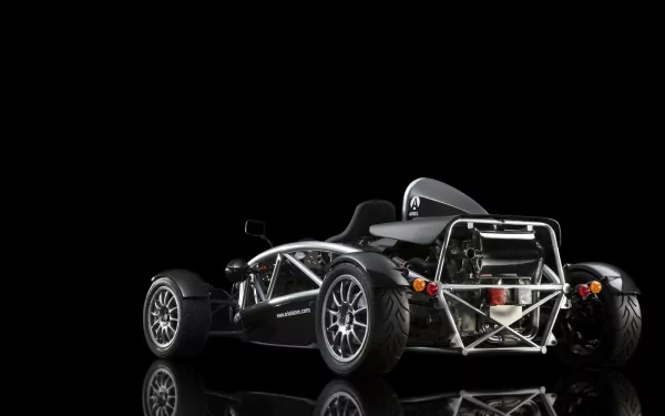 HD desktop wallpaper of a black Ariel Atom race car with a reflective surface, highlighting its sleek vehicle design against a black background.