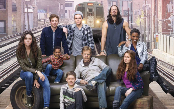 A vibrant HD wallpaper featuring the cast of the TV show Shameless. The characters pose together on a couch with a backdrop of an urban train setting, capturing the show's unique spirit.
