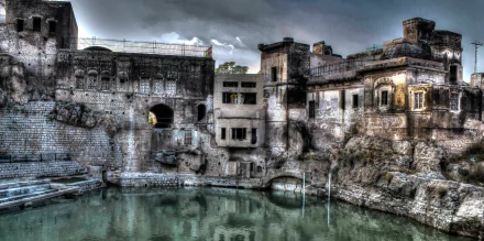 HDR image of Katasraj Temple in Pakistan with calm water reflecting the ancient religious site, captured as a high-definition desktop wallpaper background.
