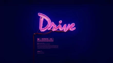 HD PC desktop wallpaper featuring the neon Drive logo from the 2011 movie, glowing against a dark background.