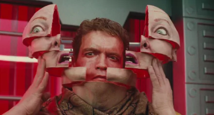 HD desktop wallpaper featuring Arnold Schwarzenegger in a striking scene from the 1990 movie Total Recall, with his face fragmented into mechanical parts.