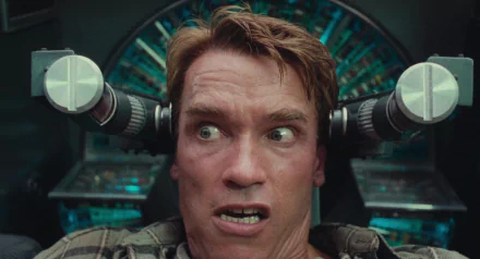 Arnold Schwarzenegger in a tense scene from the 1990 movie Total Recall, featured in an HD PC desktop wallpaper and background.