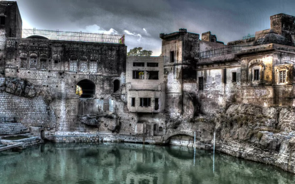 HDR image of Katasraj Temple in Pakistan with calm water reflecting the ancient religious site, captured as a high-definition desktop wallpaper background.