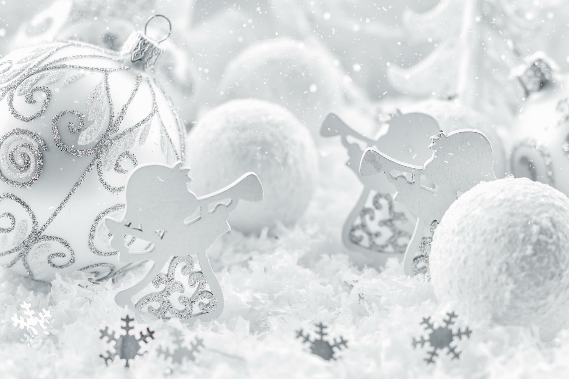 A 4K Ultra HD Christmas desktop wallpaper featuring white holiday ornaments, sparkling snowflakes, and angel decorations in a snowy, festive setting.