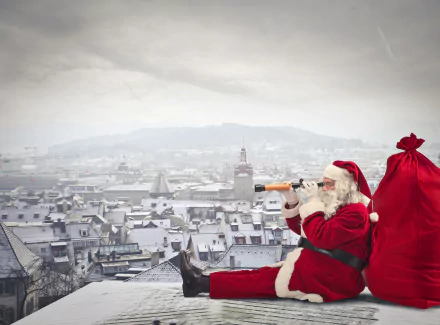 Santa sits on a snowy rooftop, peering through a telescope. His red bag is beside him, capturing the festive holiday spirit in this 4K Ultra HD desktop wallpaper.