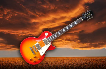 HD PC desktop wallpaper of a sunburst electric guitar floating above a golden field under dramatic orange clouds, evoking music.