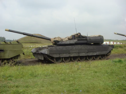 Military T-95 main battle tank on a grassy field, side view — 2K Quad HD PC desktop wallpaper/background.