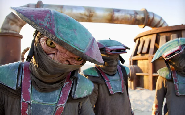 Constable Zuvio and two companions from Star Wars Episode VII: The Force Awakens stand in a desert setting, featured in a 4K Ultra HD movie desktop wallpaper.