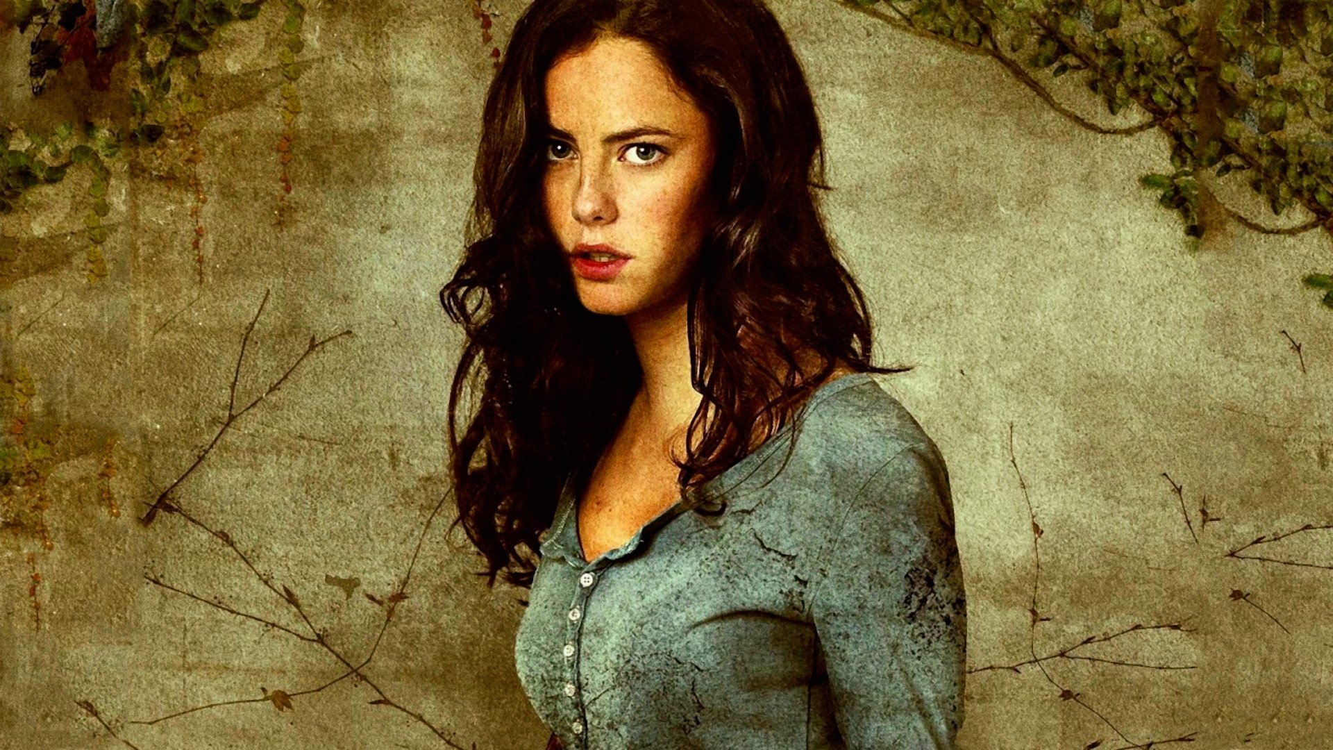 HD PC desktop wallpaper featuring a character from the movie The Maze Runner, set against a textured, earthy background with natural elements.
