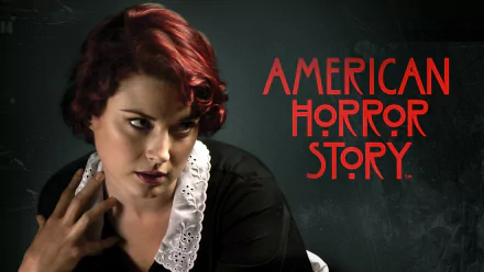 HD PC desktop wallpaper: red-haired actress in a lace-collared black dress, looking aside beside the American Horror Story TV show logo.